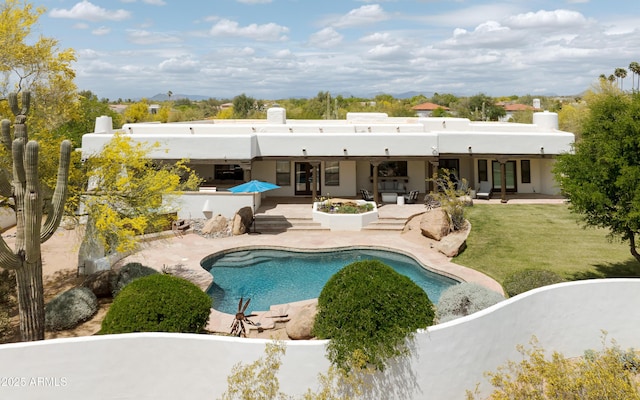 8601 E De La O Rd, Scottsdale, AZ 85255 - rear view of property featuring a patio, a chimney, an outdoor pool, and stucco siding