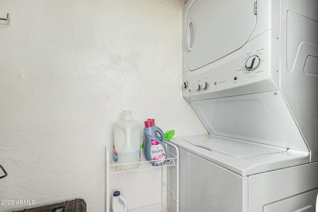 clothes washing area featuring stacked washer / dryer