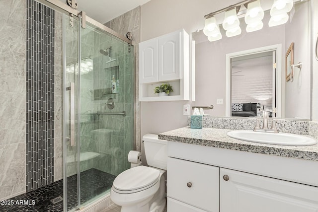 bathroom featuring walk in shower, vanity, and toilet