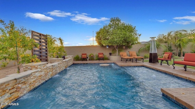 view of pool with a patio area and pool water feature