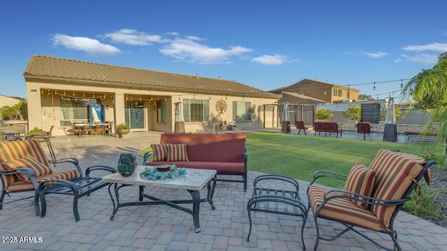 rear view of property with a yard, an outdoor hangout area, and a patio