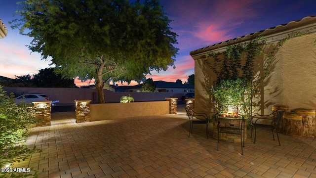 patio terrace at dusk with an outdoor kitchen