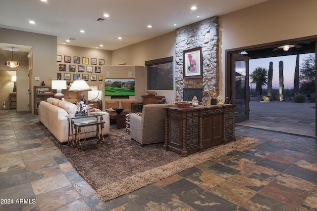 living room with a stone fireplace