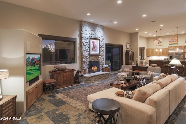 living room featuring a stone fireplace