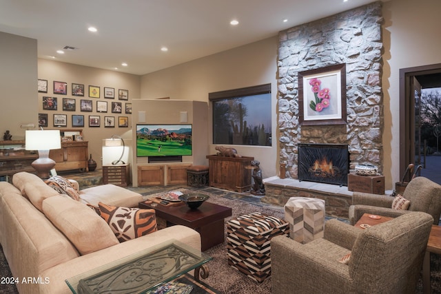 living room with a stone fireplace