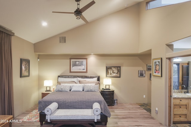 bedroom with connected bathroom, light hardwood / wood-style flooring, high vaulted ceiling, and ceiling fan