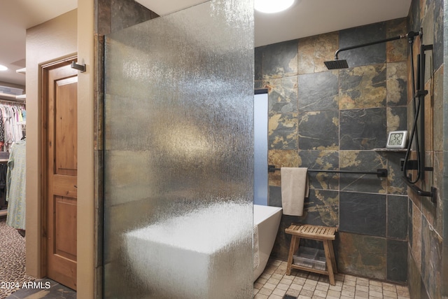 bathroom with shower with separate bathtub and tile walls