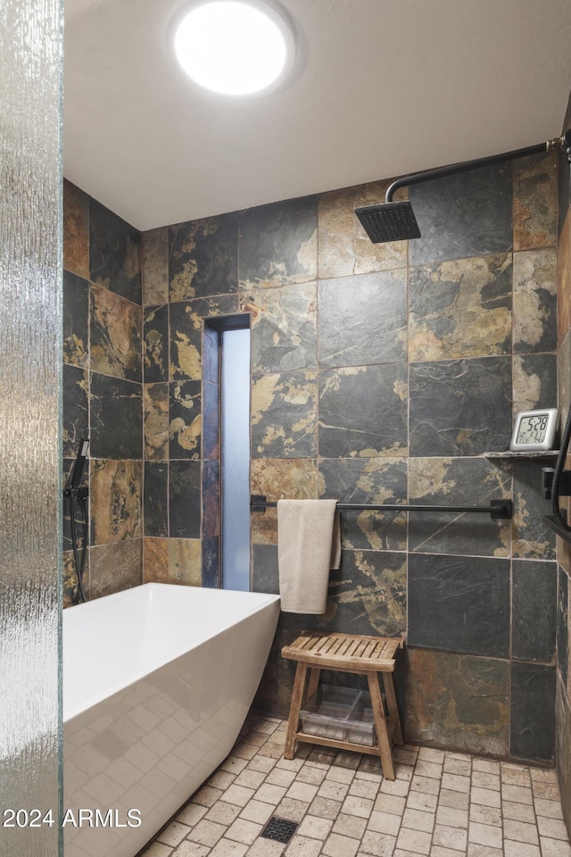 bathroom featuring tile walls and shower with separate bathtub