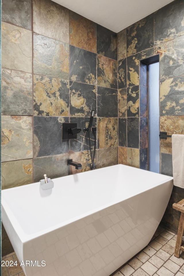 bathroom with tile walls and a bathing tub