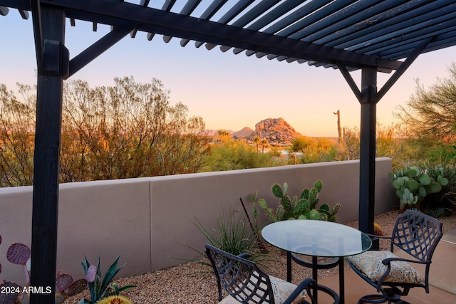 patio terrace at dusk featuring a pergola