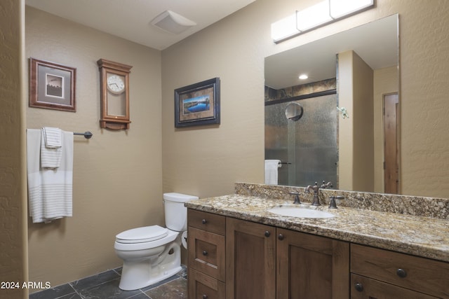 bathroom featuring vanity, toilet, and an enclosed shower