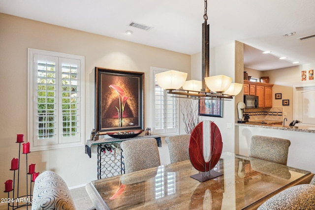 dining space featuring a notable chandelier