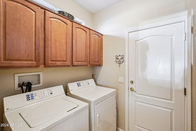 washroom with cabinets and independent washer and dryer