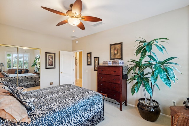 carpeted bedroom with ceiling fan and a closet