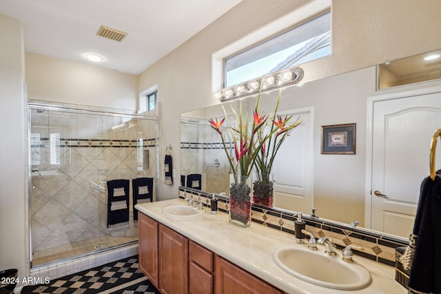 bathroom with vanity, a skylight, and an enclosed shower