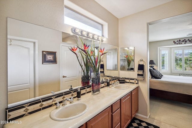 bathroom with tile patterned floors, backsplash, and vanity