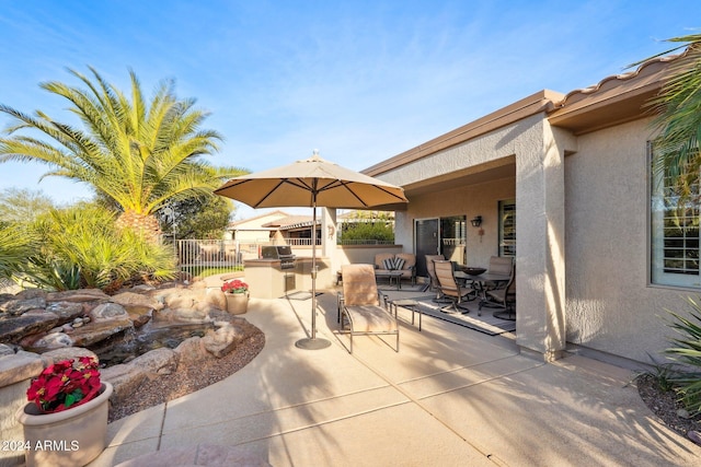 view of patio featuring a grill and an outdoor kitchen