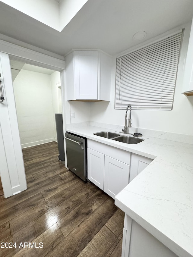 kitchen with dishwasher, white cabinets, sink, dark hardwood / wood-style floors, and light stone countertops