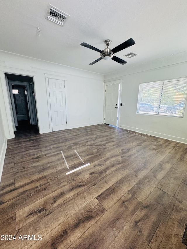 spare room featuring ceiling fan and dark hardwood / wood-style floors