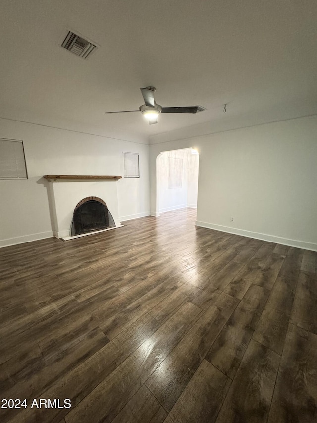 unfurnished living room with dark hardwood / wood-style floors and ceiling fan