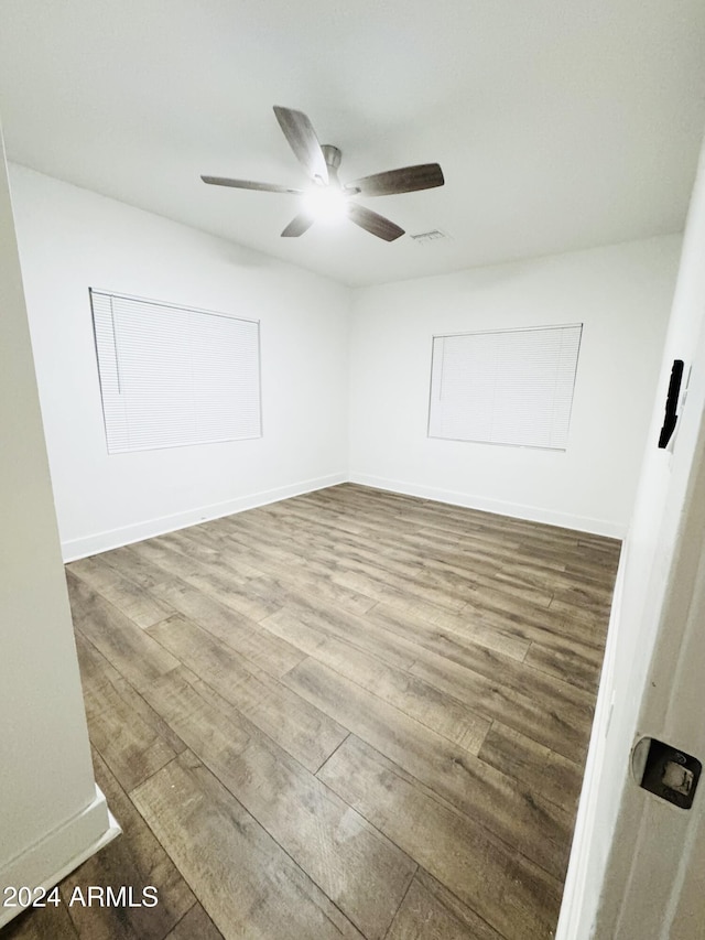 spare room featuring hardwood / wood-style floors and ceiling fan