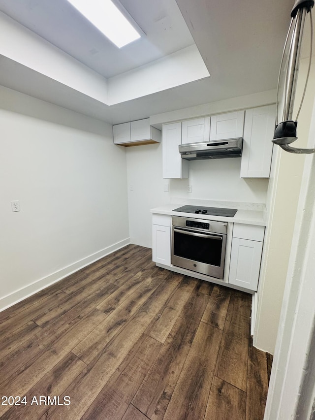 kitchen with white cabinetry, stainless steel oven, black stovetop, and ventilation hood