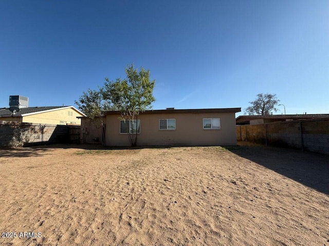 back of property featuring fence