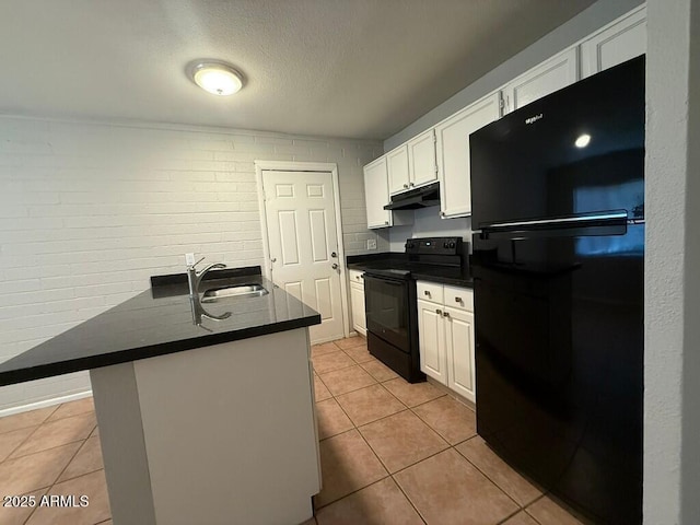kitchen with dark countertops, under cabinet range hood, white cabinetry, black appliances, and light tile patterned floors