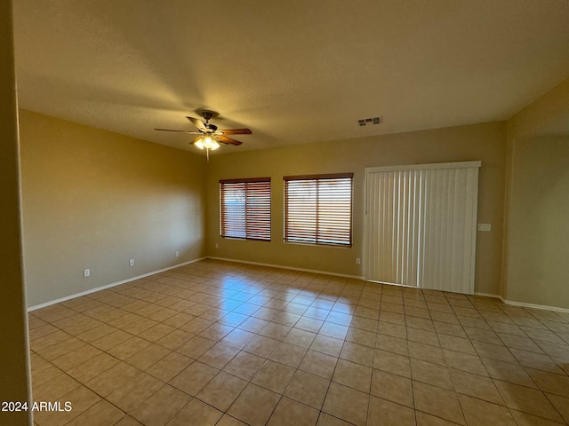 tiled spare room featuring ceiling fan and a textured ceiling