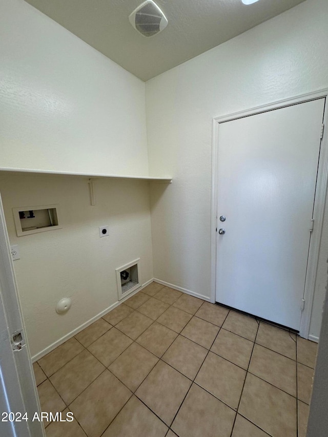 clothes washing area with hookup for a washing machine, hookup for a gas dryer, light tile patterned floors, and electric dryer hookup