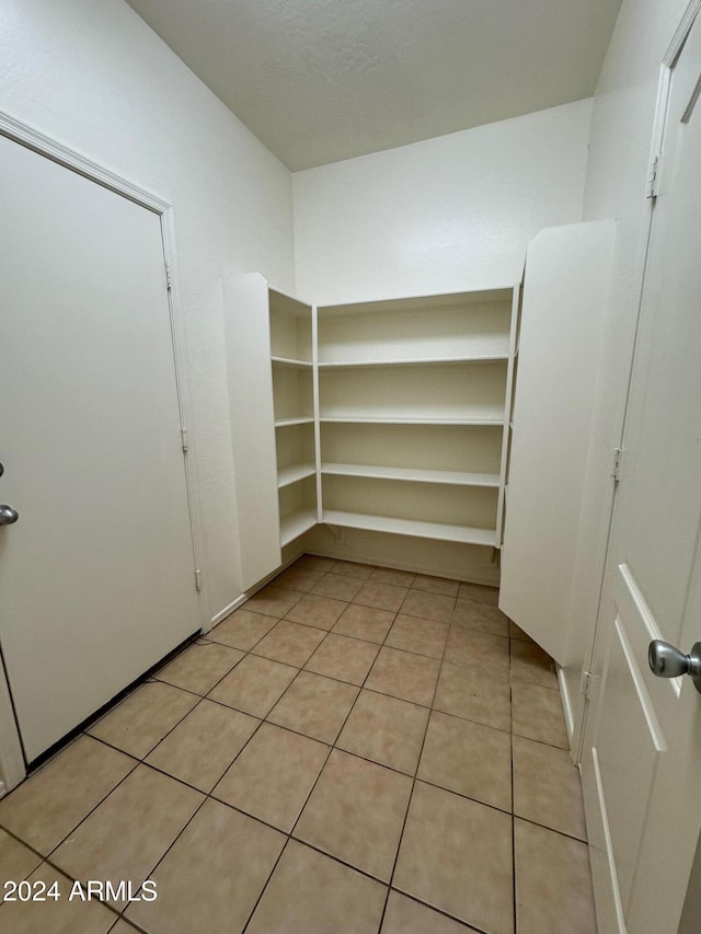 spacious closet featuring light tile patterned floors