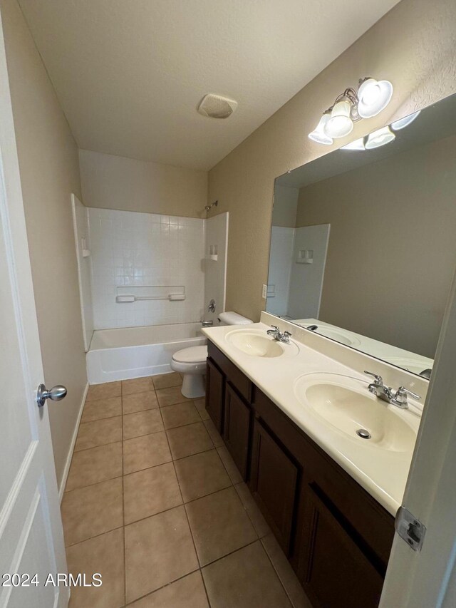 full bathroom with tile patterned flooring, vanity, toilet, and tiled shower / bath