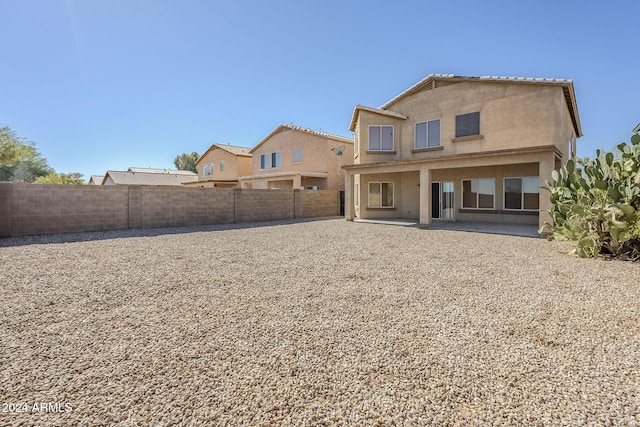 rear view of property featuring a patio area