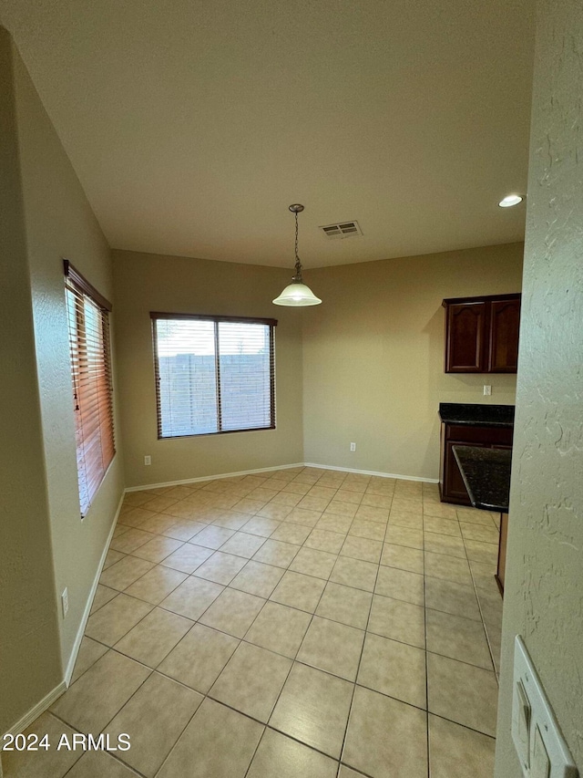 unfurnished dining area with light tile patterned floors