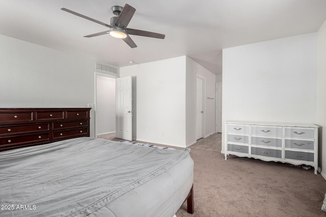 bedroom with carpet flooring, ceiling fan, baseboards, and visible vents