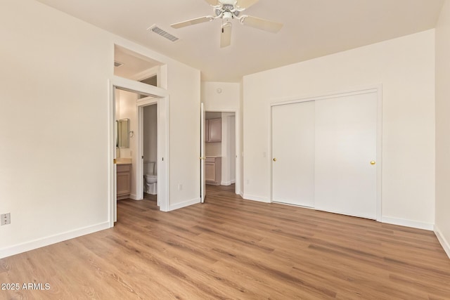 unfurnished bedroom featuring a ceiling fan, visible vents, baseboards, a closet, and light wood-style flooring