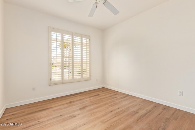 empty room with baseboards, a ceiling fan, and wood finished floors