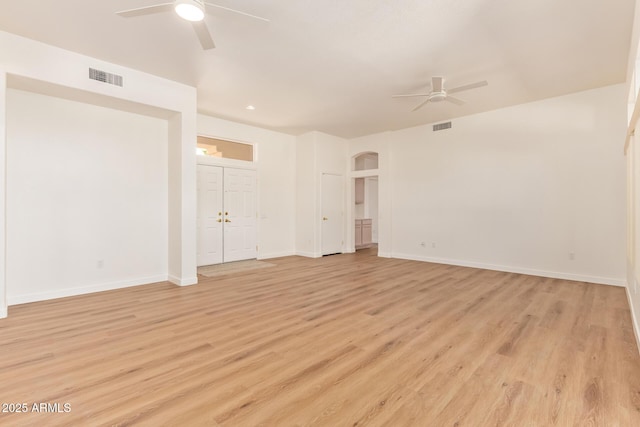 unfurnished room featuring ceiling fan, light wood-type flooring, and visible vents