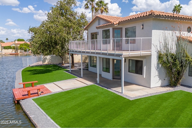3520 N 110th Ave, Avondale, AZ 85392 - back of property with a water view, a tiled roof, stucco siding, a lawn, and a patio area
