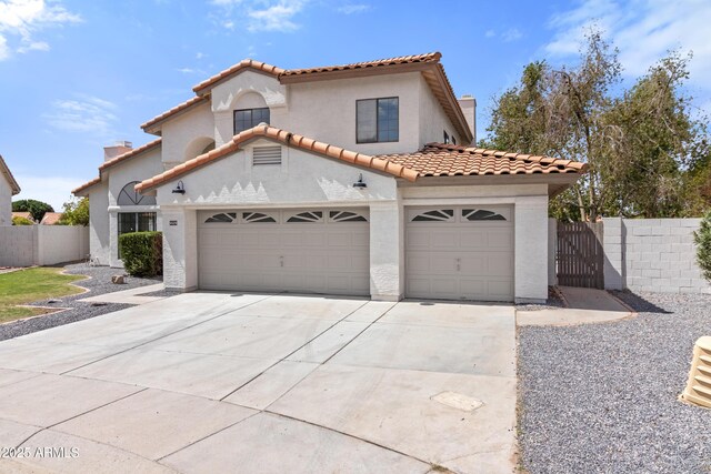 3520 N 110th Ave, Avondale, AZ 85392 - mediterranean / spanish house featuring a tile roof, driveway, stucco siding, and fence