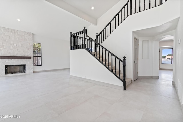 3520 N 110th Ave, Avondale, AZ 85392 - stairs featuring arched walkways, a high ceiling, baseboards, and a healthy amount of sunlight