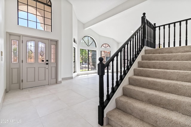 3520 N 110th Ave, Avondale, AZ 85392 - entrance foyer featuring stairs, light tile patterned floors, high vaulted ceiling, baseboards, and beam ceiling