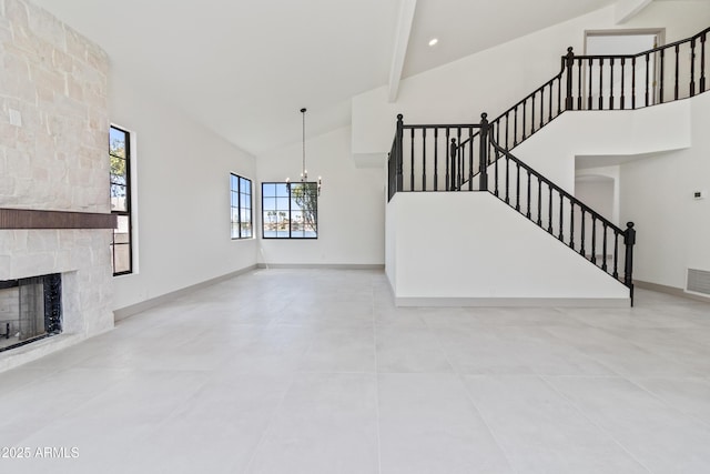 3520 N 110th Ave, Avondale, AZ 85392 - unfurnished living room with high vaulted ceiling, visible vents, a chandelier, stairway, and a stone fireplace