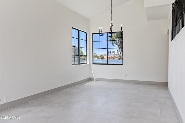 3520 N 110th Ave, Avondale, AZ 85392 - unfurnished room with baseboards, a towering ceiling, and an inviting chandelier