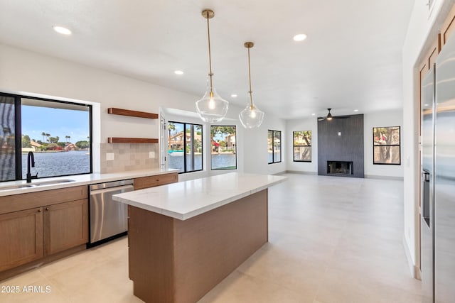 3520 N 110th Ave, Avondale, AZ 85392 - kitchen with stainless steel appliances, a ceiling fan, tasteful backsplash, a sink, and a center island