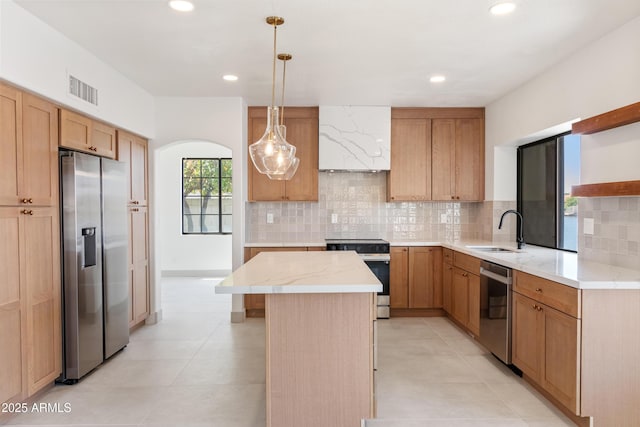 3520 N 110th Ave, Avondale, AZ 85392 - kitchen featuring a sink, stainless steel appliances, a center island, and tasteful backsplash