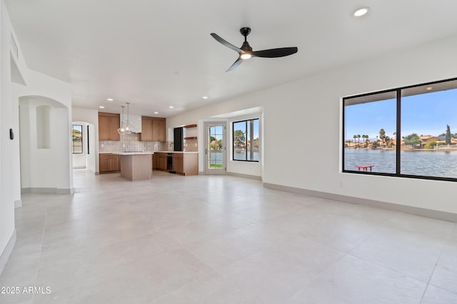 3520 N 110th Ave, Avondale, AZ 85392 - unfurnished living room with a ceiling fan, arched walkways, baseboards, and recessed lighting