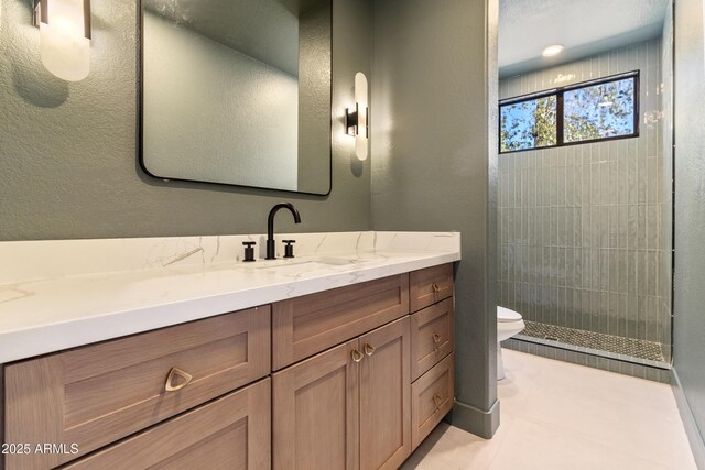 3520 N 110th Ave, Avondale, AZ 85392 - bathroom featuring tile patterned floors, a tile shower, toilet, and vanity