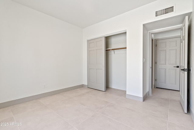 3520 N 110th Ave, Avondale, AZ 85392 - unfurnished bedroom with light tile patterned floors, a closet, baseboards, and visible vents