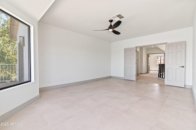 3520 N 110th Ave, Avondale, AZ 85392 - spare room featuring light tile patterned flooring, baseboards, visible vents, and a ceiling fan